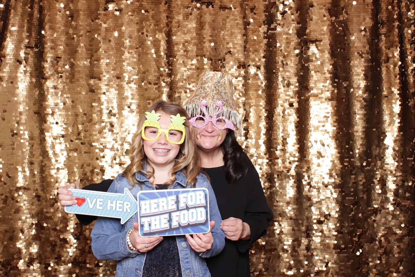 photo booth photo from a wedding reception with gold sequin backdrop