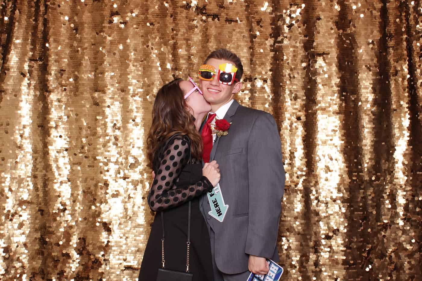 photo booth photo from a wedding reception with gold sequin backdrop