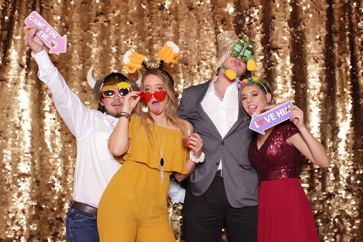 photo booth photo from a wedding reception with gold sequin backdrop