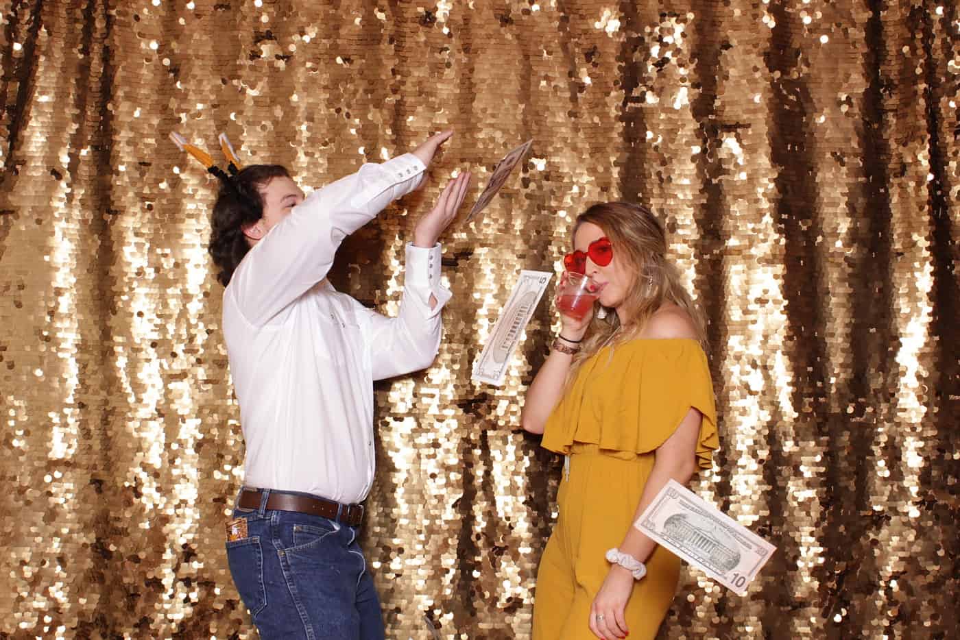 photo booth photo from a wedding reception with gold sequin backdrop