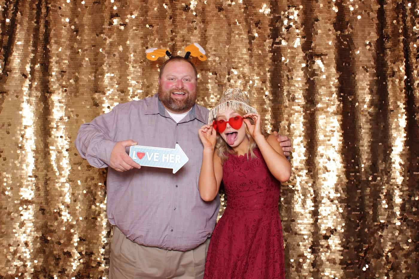 photo booth photo from a wedding reception with gold sequin backdrop