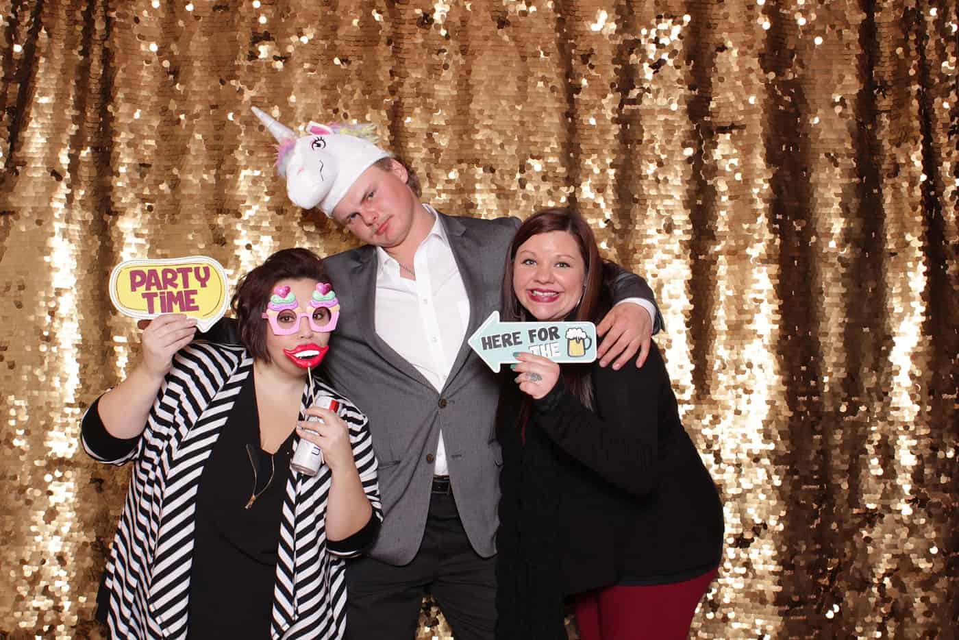 photo booth photo from a wedding reception with gold sequin backdrop