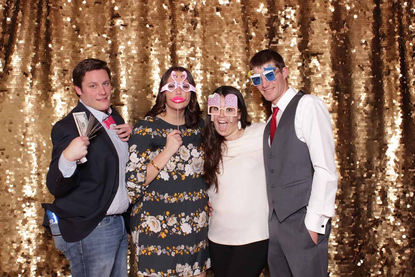 photo booth photo from a wedding reception with gold sequin backdrop