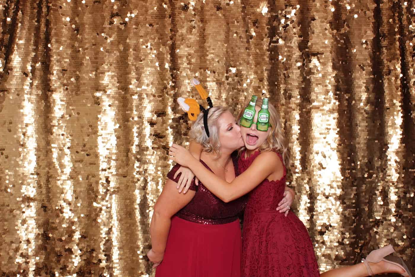 photo booth photo from a wedding reception with gold sequin backdrop
