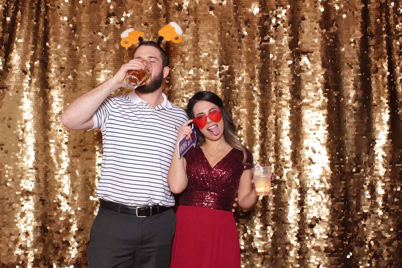 photo booth photo from a wedding reception with gold sequin backdrop