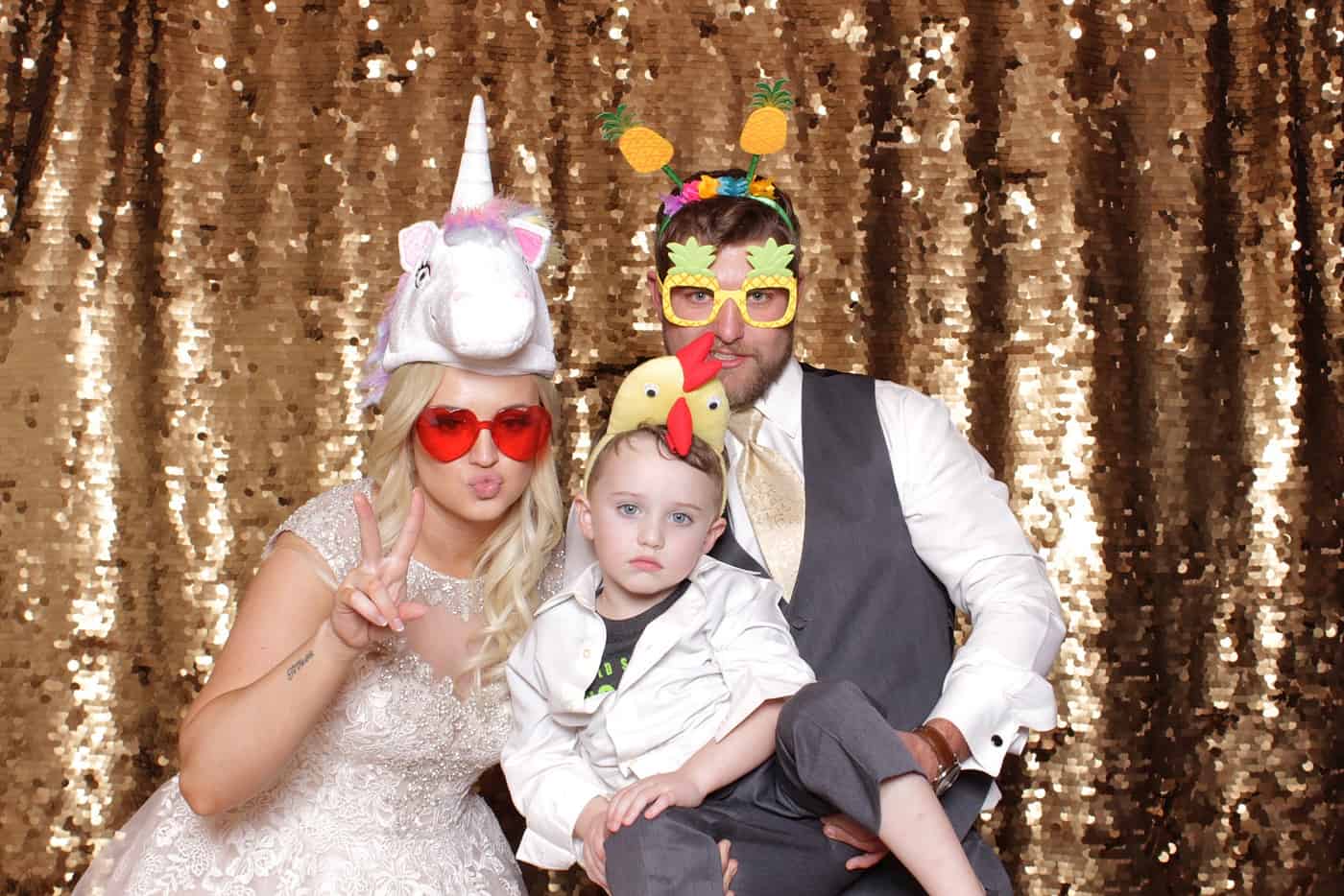 photo booth photo from a wedding reception with gold sequin backdrop