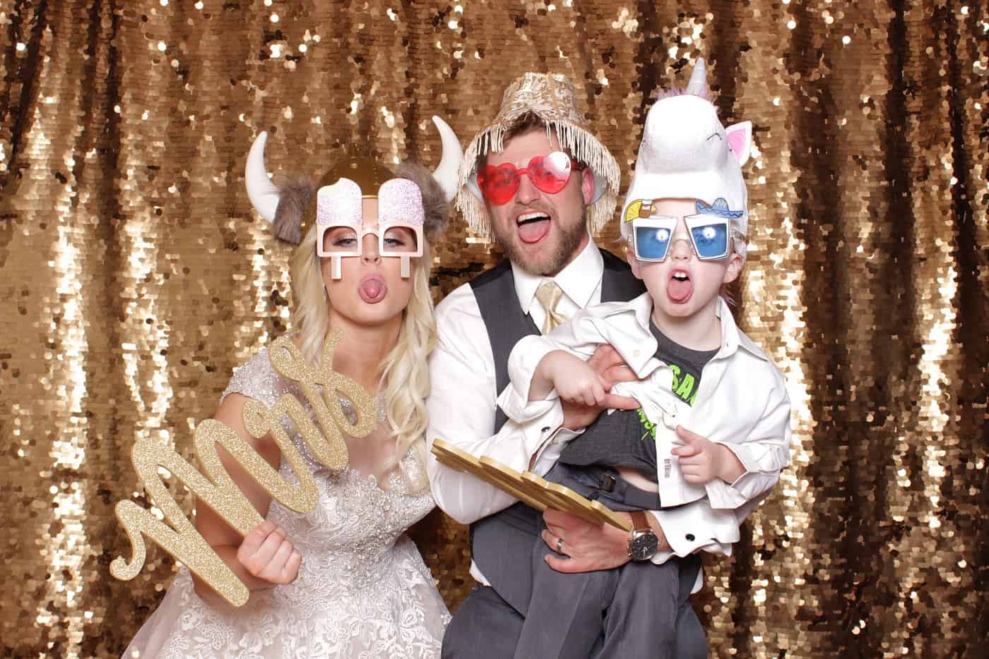 photo booth photo from a wedding reception with gold sequin backdrop