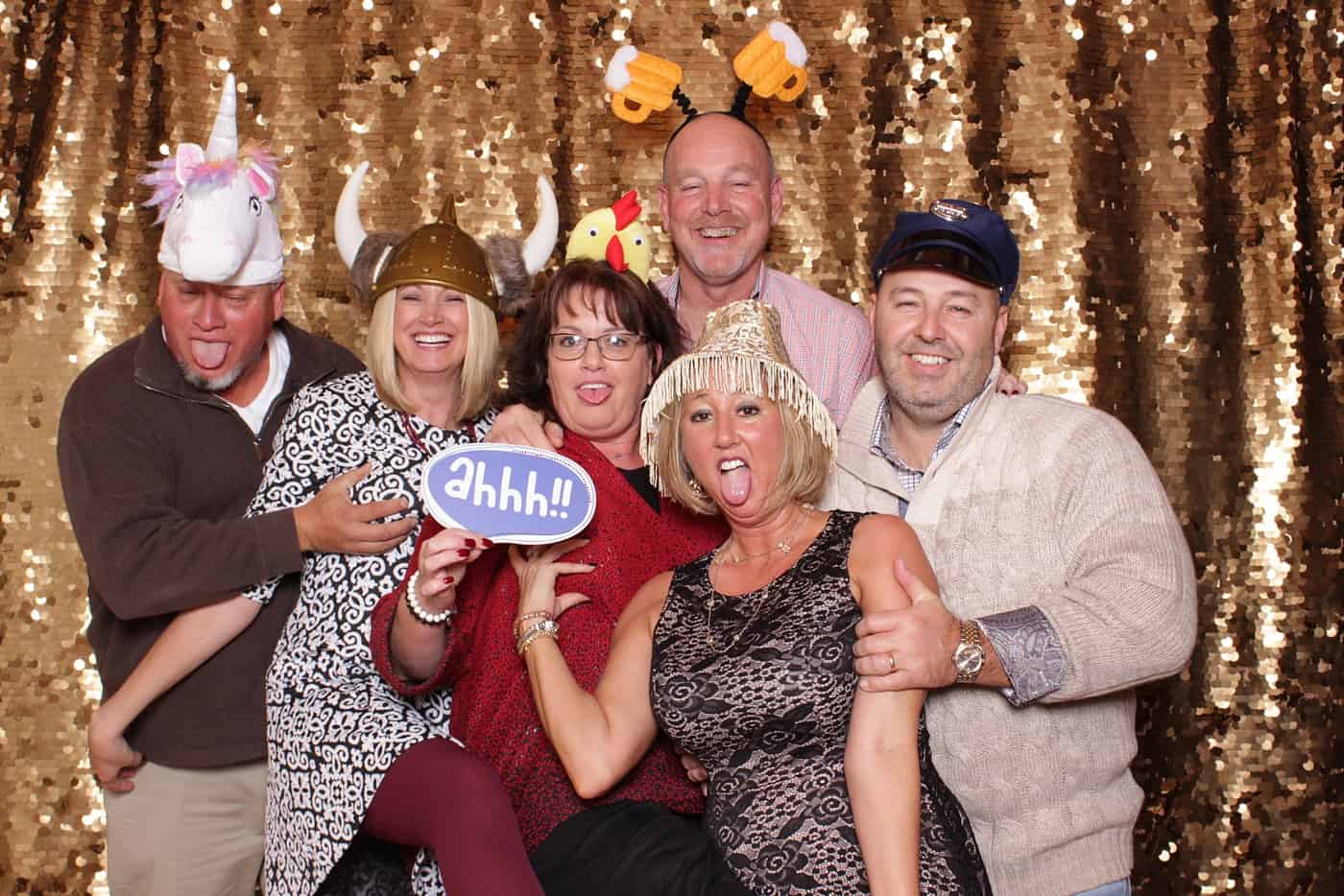 photo booth photo from a wedding reception with gold sequin backdrop