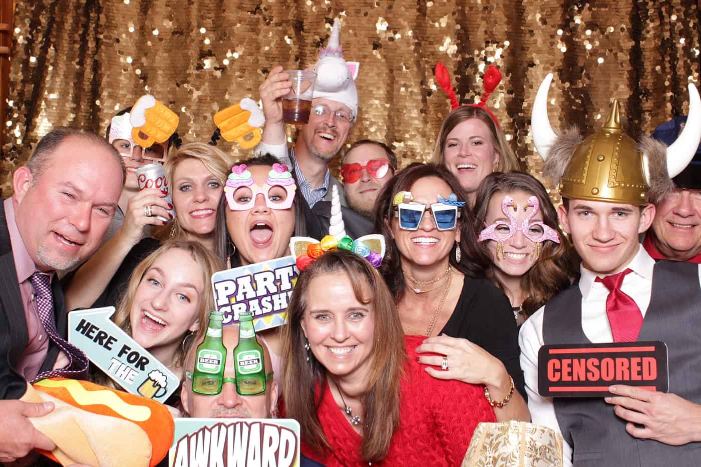 photo booth photo from a wedding reception with gold sequin backdrop