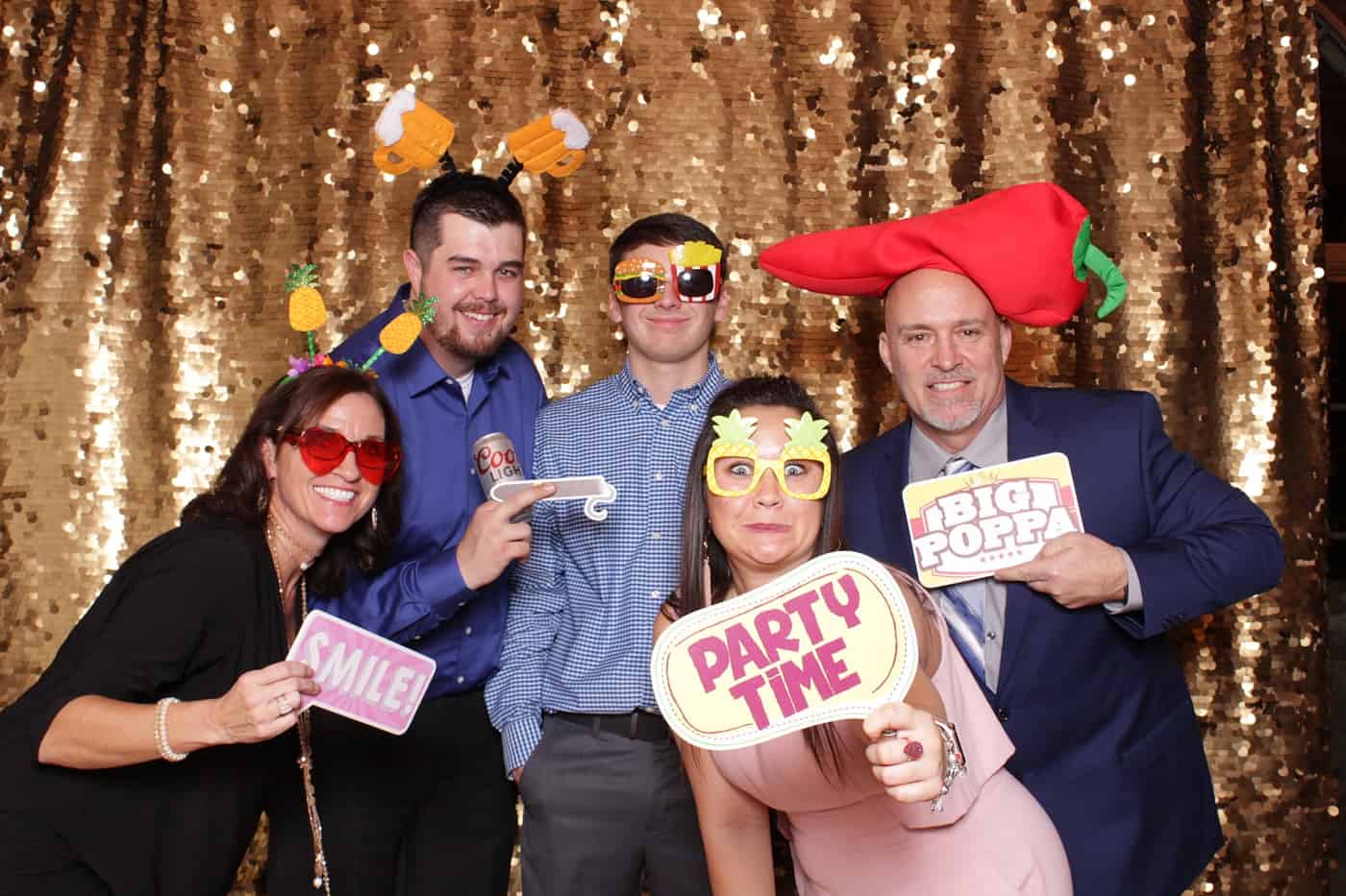 photo booth photo from a wedding reception with gold sequin backdrop