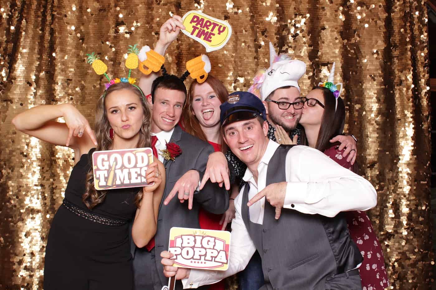 photo booth photo from a wedding reception with gold sequin backdrop