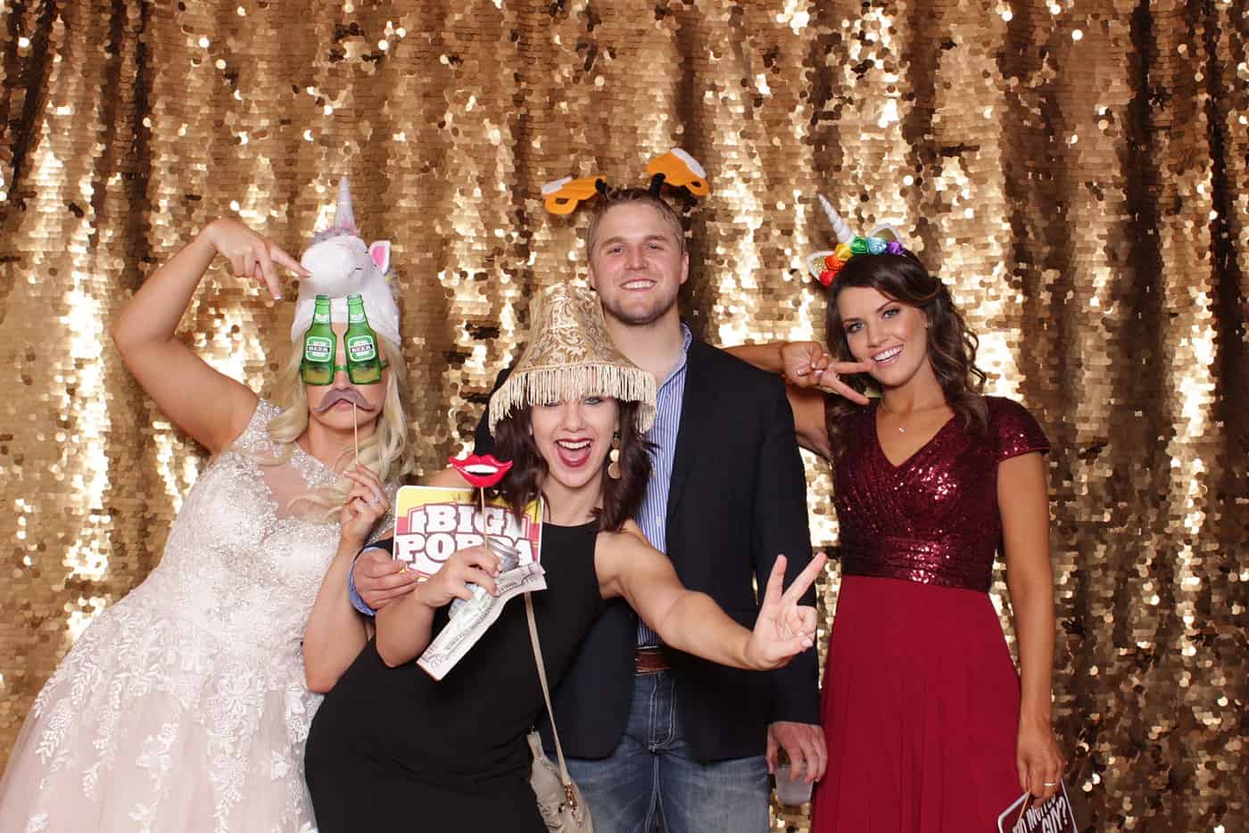 photo booth photo from a wedding reception with gold sequin backdrop